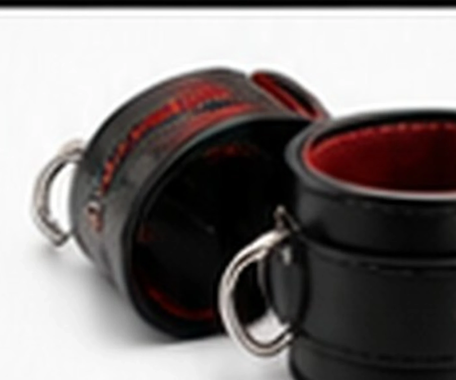 Black leather cuffs with red lining